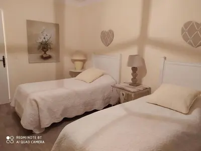 a bedroom with two beds and a lamp on a table at Holiday Home Schöne provenzalische Villa Les Carlets mit Pool by Interhome in Saignon