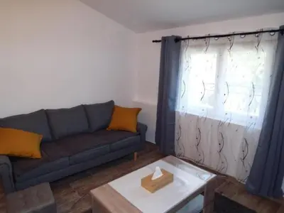 a living room with a couch and a table at Apartment Leonie's Gîte Moulin de Tartay in Avignon by Interhome in Avignon