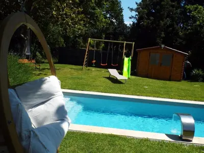 a swimming pool with a swing and a playground at Apartment Leonie's Gîte Moulin de Tartay in Avignon by Interhome in Avignon