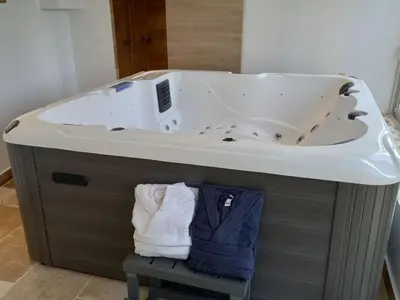 a bathroom with a bath tub with a sink at Holiday Home Moulin de Tartay in Avignon by Interhome in Avignon