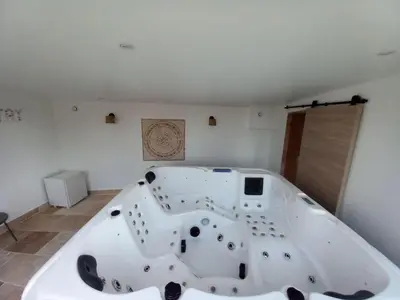 a large white bath tub in a room at Holiday Home Moulin de Tartay in Avignon by Interhome in Avignon