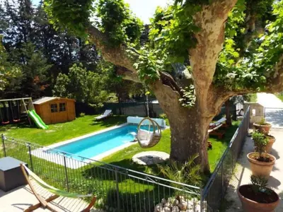 a backyard with a tree and a swimming pool at Holiday Home Moulin de Tartay in Avignon by Interhome in Avignon