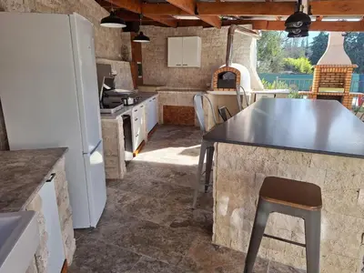 a kitchen with a refrigerator and a table in a room at Holiday Home Moulin de Tartay in Avignon by Interhome in Avignon