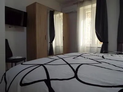 a bedroom with a bed with a black and white blanket at Holiday Home Moulin de Tartay in Avignon by Interhome in Avignon