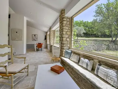 a living room with a couch and a large window at Holiday Home Domaine Santonne by Interhome in Apt