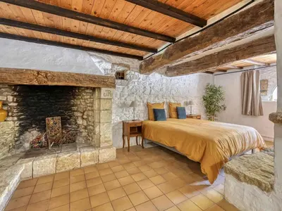 a bedroom with a bed and a stone wall at Holiday Home Domaine Santonne by Interhome in Apt