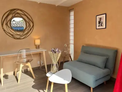a living room with a couch and a table and chairs at Holiday Home Das Atelier im Mas Naste by Interhome in Eygalières