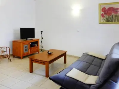 a living room with a blue couch and a tv at Apartment Morard - Bonnieux Appt Bleu Provence by Interhome in Bonnieux