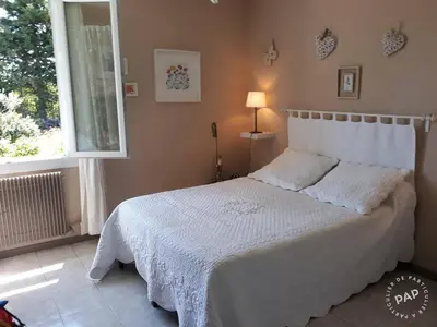 a bedroom with a white bed with a window at Villa en Provence in Le Thor