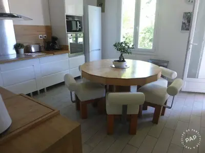 a kitchen with a wooden dining table and chairs at Villa en Provence in Le Thor