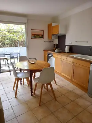 a kitchen with a table and chairs and a dining room at Hébergement tout confort au pied du Luberon in Cabrières-dʼAigues