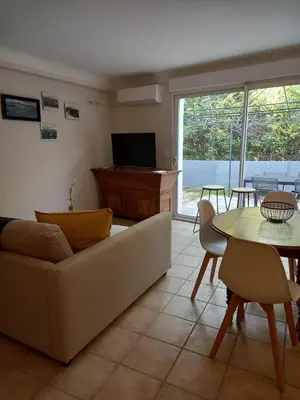 a living room with a couch and a table at Hébergement tout confort au pied du Luberon in Cabrières-dʼAigues