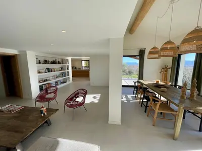 a living room with a dining room table and chairs at Lourmarin, Maison De Charme Au Coeur Du Luberon in Cadenet