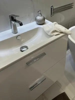 a white bathroom sink with a towel on it at Le Pavillon Etoile in Venelles