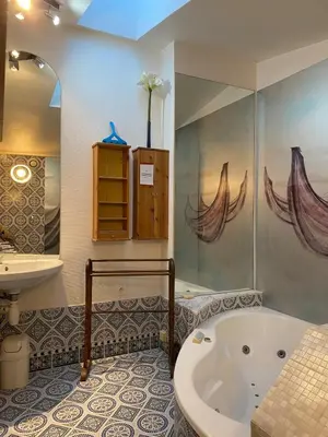 a bathroom with a tub and a sink at Danie, maison des oliviers et vue Luberon in Maubec