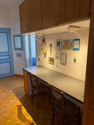 a kitchen with a counter with chairs and a counter top at Danie, maison des oliviers et vue Luberon in Maubec