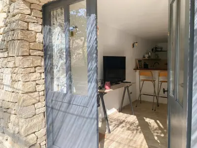 a door to a room with a stone wall at LAVANDE in Apt