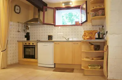 a kitchen with a white refrigerator and a sink at Les Roues de L'Isle - CHARMING APARTMENT in LʼIsle-sur-la-Sorgue