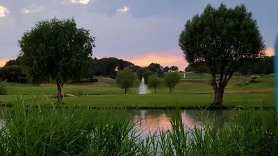 a pond in a field with trees and a waterfall at Les Roues de L'Isle - CHARMING APARTMENT in LʼIsle-sur-la-Sorgue