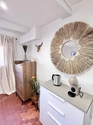 a kitchen with a mirror and a dresser at Aix-en-Provence, Studio rénové au coeur de ville Calme absolu in Aix-en-Provence