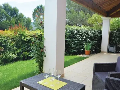a patio with wine glasses on a table at Maison climatisée 6 pers. avec piscines au Domaine Pont Royal - FR-1-658-38 in Mallemort