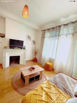 a living room with a coffee table and a fireplace at appartement de charme au coeur d'aix en provence in Aix-en-Provence