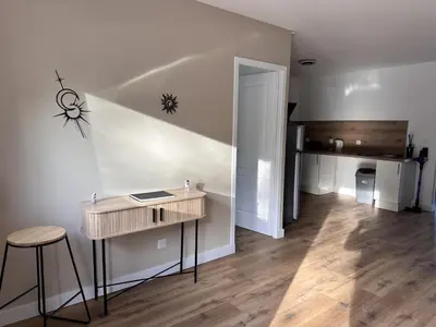 a room with a desk and a hallway with a staircase at L'abeille sous les étoiles in Saint-Michel-lʼObservatoire