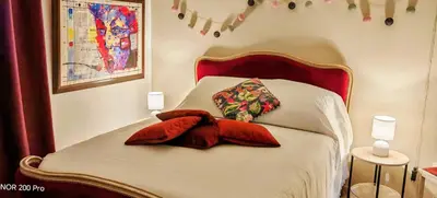 a bed with two pillows on top of it at Charmant studio aux portes des Alpilles in Eyguières