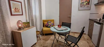 a small room with a table and a chair at Charmant studio aux portes des Alpilles in Eyguières
