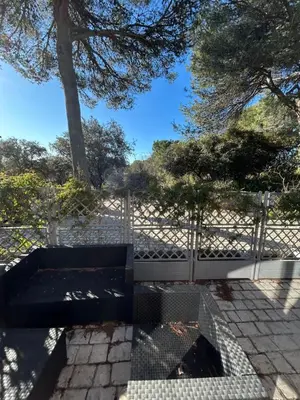 a bench sitting in front of a fence at T2 avec Terrasse à Ventabren proche Aix in Ventabren