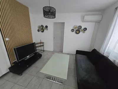 a living room with a couch and a table at Le cocon de mag in Miramas