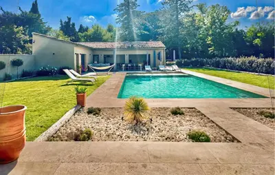 a backyard with a swimming pool and a house at Amazing Home In Noves in Noves