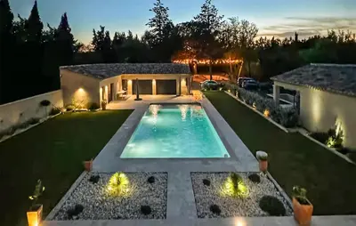 a backyard with a swimming pool and a house at Amazing Home In Noves in Noves