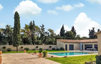 a house with a swimming pool in a yard at Amazing Home In Noves in Noves