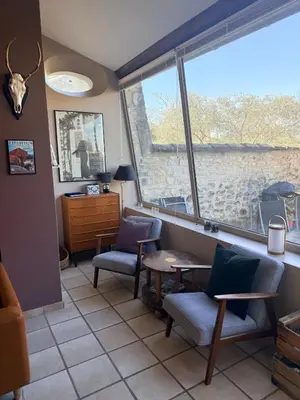 a dining room table with chairs and a painting on the wall at Karen house with courtyard at the foot of the Luberon in Maubec