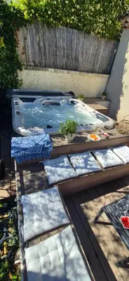 a wooden table with plates of food on it at Villa de charme avec piscine et jacuzzi en Provence in Châteauneuf-de-Gadagne