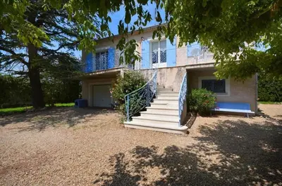 a house with a staircase in front of it at Les Volets Bleus Provençal house with pool in LʼIsle-sur-la-Sorgue