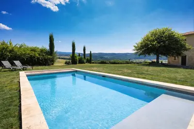 a swimming pool in the backyard of a villa at La Grange Blanche in Sault-de-Vaucluse