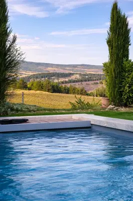 a swimming pool with a view of a field at La Grange Blanche in Sault-de-Vaucluse