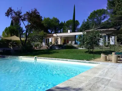 a villa with a swimming pool in front of a house at Villa Cezanne Panorama, City Center on Foot in Aix-en-Provence