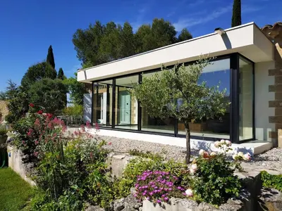 a house with glass windows and flowers at Villa Cezanne Panorama, City Center on Foot in Aix-en-Provence