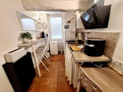 a small kitchen with a sink and a counter at Le Cocon d'Emy in Aix-en-Provence