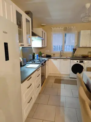 a kitchen with white cabinets and a stove top oven at Villa Sérénité Jardin et Calme in Revest-du-Bion