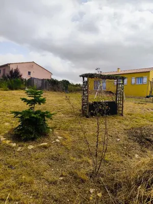 a small yellow house in a field with a tree at Villa Sérénité Jardin et Calme in Revest-du-Bion