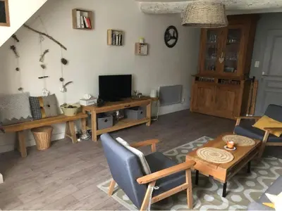 a living room with a couch and a table and a tv at La Cigale Bleue in Villes-sur-Auzon