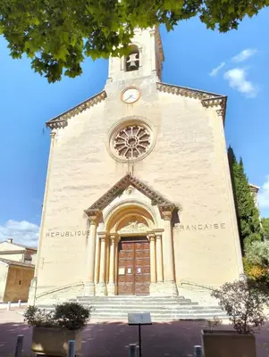 a tall building with a clock tower on it at La Cigale Bleue in Villes-sur-Auzon