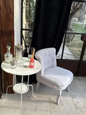 a white chair and a table and a chair and a table at luxury farm jacuzzi heated pool in Isle sur la sorgue in Lagnes