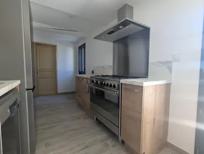 a kitchen with a stove and a counter top at La Ferme Au bord de l etang de la Bonde in Sannes