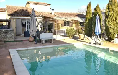 a house with a swimming pool in front of a house at Maison Avec Piscine Privée in Entraigues-sur-la-Sorgue