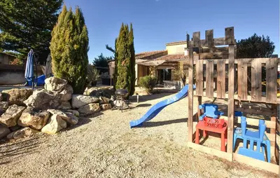 a playground with a slide in a yard at Maison Avec Piscine Privée in Entraigues-sur-la-Sorgue